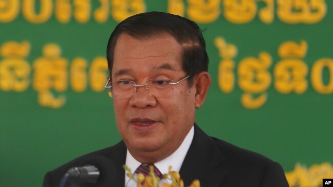 In this Feb. 7, 2021, file photo, Cambodian Prime Minister Hun Sen delivers a speech during a handover ceremony at Phnom Penh International Airport, in Phnom Penh, Cambodia.