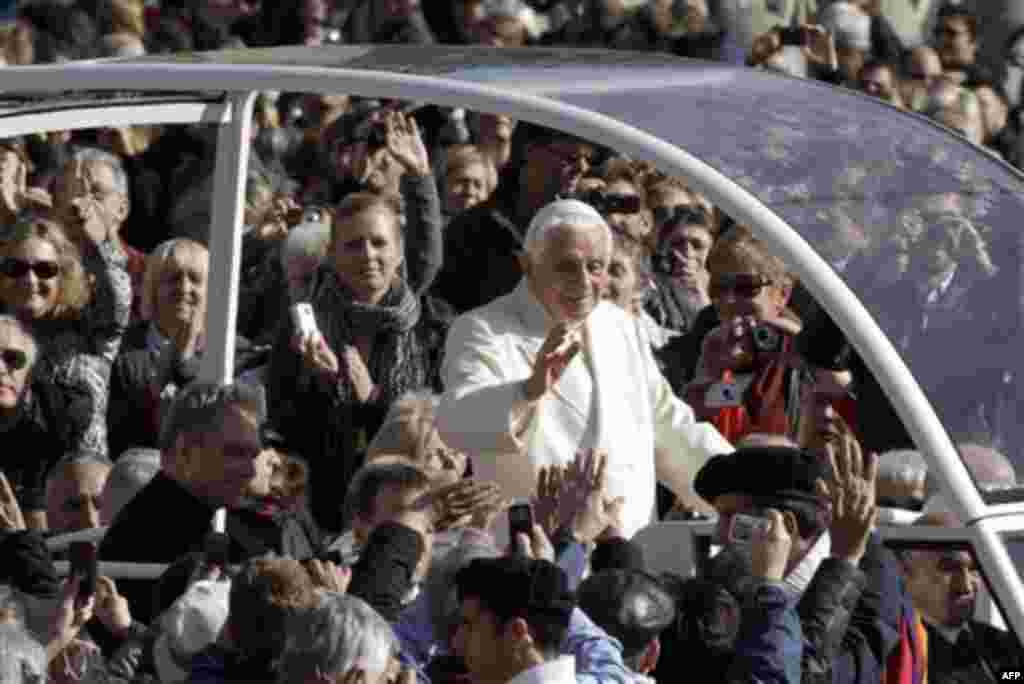 Pope Benedict XVI salutes the faithful as he arrives on his pope-mobile for his weekly general audience, in St. Peter square, at the Vatican, Wednesday, Nov. 17, 2010. (AP Photo/Alessandra Tarantino)