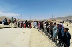 Hundreds of people gather outside the international airport in Kabul, Afghanistan, Aug. 17, 2021.