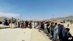 Hundreds of people gather outside the international airport in Kabul, Afghanistan, Aug. 17, 2021.