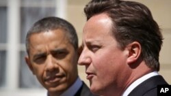 Britain's Prime Minister David Cameron (R) speaks during a joint news conference with U.S. President Barack Obama at Lancaster House, in central London, May 25, 2011