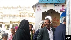 Sally al-Sahabi, 12, and her father enter the police station, hoping that having her husband arrested will pressure him into granting her a divorce