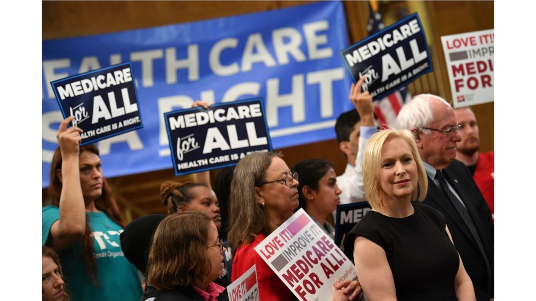 FILE - Democratic 2020 presidential hopefuls Sen. Kirsten Gillibrand (D-NY) and Bernie Sanders (I-VT) attend a Medicare For All event on Capitol Hill in Washington, April 10, 2019.