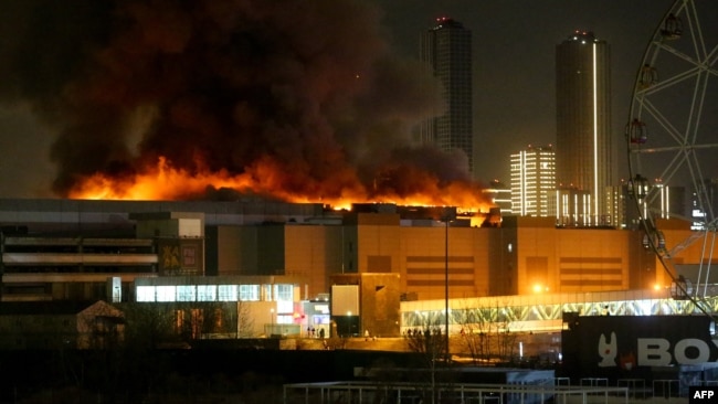 Crocus City Hall, a large music venue on Moscow’s western edge, burns after a shooting, March 22, 2024. (AFP Photo/Moskva News Agency) Assailants