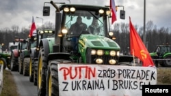 Polish farmers protest over price pressures, taxes and green regulation, grievances shared by farmers across Europe and against the import of agricultural produce and food products from Ukraine, as they block roads in Gorzyczki, Poland, Feb. 20, 2024. 