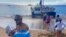 Volunteers who sailed from Maalaea Bay, Maui, form an assembly line on Kaanapali Beach on Aug. 12, 2023, to unload donations. The Maui fire damaged water pipes, resulting in a loss of pressure that likely allowed toxic chemicals along with metals and bacteria into water lines. 