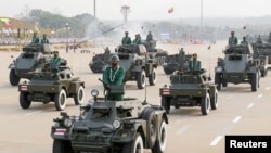 FILE - Military personnel participates in a parade on Armed Forces Day in Naypyitaw, Myanmar, March 27, 2021. 