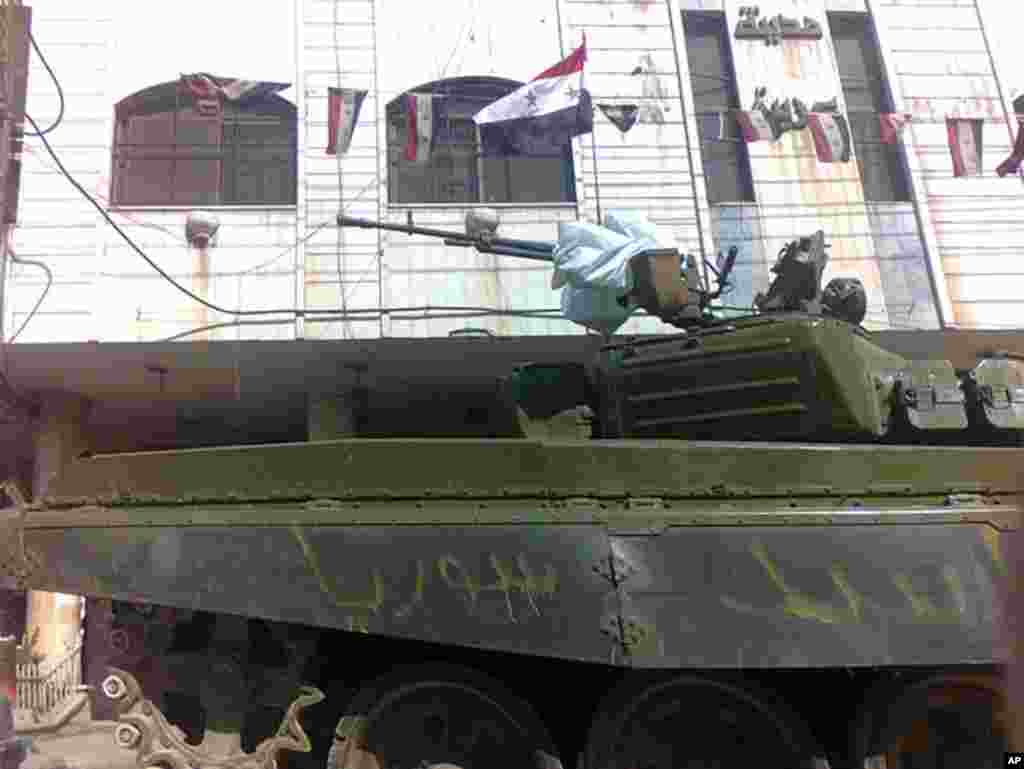 A Syrian army tank in the neighborhood of Erbeen, near Damascus, February 20, 2012. The words on the tank read, "Assad, Syria". (Reuters)