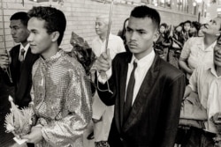 Ricky, the groom, is escorted during a Cambodian traditional wedding ceremony in Uptown, Chicago, 1990s. (Stuart Isett)