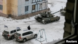 The Organization for Security and Cooperation in Europe (OSCE) cars and tanks are seen in the government-held industrial town of Avdiivka, Ukraine, Feb. 1, 2017.