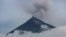 FILE - A plume of smoke and ash rises from the Volcano of Fire, June 15, 2018, as seen from San Miguel Los Lotes, Guatemala. Guatemala's Volcano of Fire, one of the region's most active, started spewing ash again Friday.