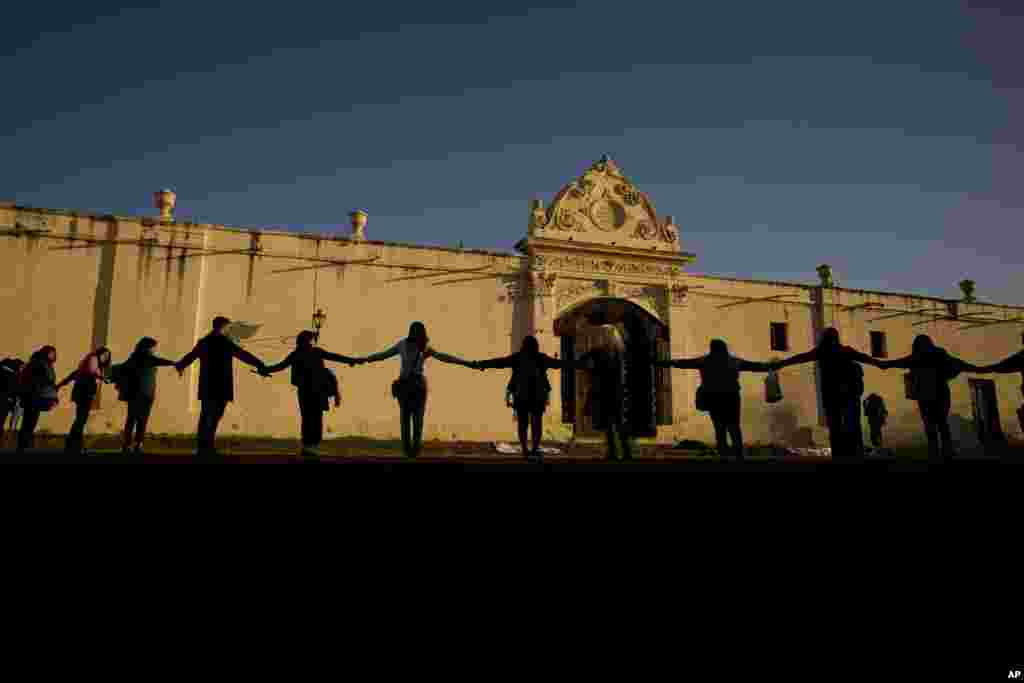 Women holding hands, rally outside the San Bernardo Convent in Salta, Argentina, May 3, 2022, in support of the convent&#39;s cloistered nuns who have accused the Archbishop of Salta province Mario Antonio Cargnello and other church officials of gender-based psychological and physical violence.