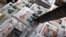 FILE - A man points to a newspaper among the stacks of offerings, in Addis Ababa, Ethiopia, June 24, 2019. 