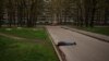 FILE - The body of a man killed during a Russian bombardment lies on a street in a residential neighborhood in Kharkiv, Ukraine, April 19, 2022.