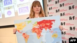 Reporters Without Borders Director of Operations and Campaigns Rebecca Vincent shows the new 2022 World Press Freedom Index map during the Reporters Without Borders press conference in London on May 3, 2022.