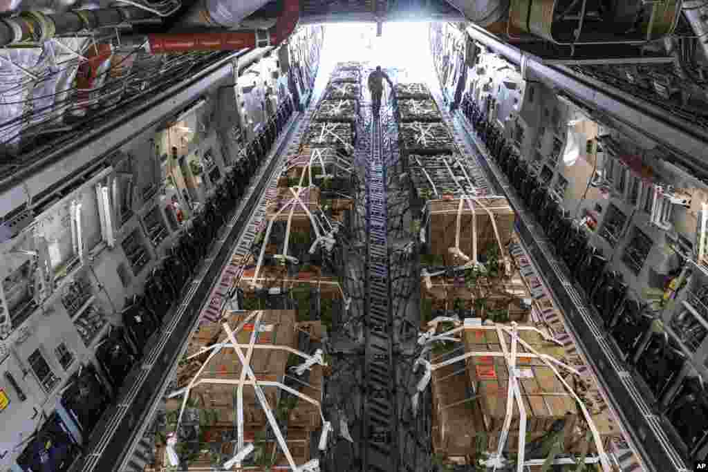 A C-17 cargo aircraft is loaded with 155 mm shells and fuses, ultimately bound for Ukraine, April 29, 2022, at Dover Air Force Base, Del.