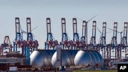 FILE - Tanks for producing bio gas are pictured at the harbor in Hamburg, Germany, April 19, 2022. Germany says it’s making progress on weaning itself off Russian fossil fuels and expects to be fully independent of crude oil imports from Russia by late summer.