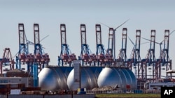 FILE - Tanks for producing bio gas are pictured at the harbor in Hamburg, Germany, April 19, 2022. Germany says it’s making progress on weaning itself off Russian fossil fuels and expects to be fully independent of crude oil imports from Russia by late su