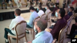 Inmates convicted on terror charges attend a ceremony that is part of a reconciliation program to rehabilitate and de-radicalize them, in Sale, Morocco, April 28, 2022. 