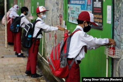 Siswa SD yang memakai masker sedang mencuci tangan usai sekolah, di Jakarta, 30 Agustus 2021. (Foto: REUTERS/Ajeng Dinar Ulfiana)