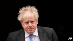 British Prime Minister Boris Johnson leaves 10 Downing Street to attend the weekly Prime Minister's Questions at the Houses of Parliament, in London, Wednesday, April 27, 2022.