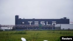 FILE - Tesla signage is seen at its factory in Shanghai, China, May 13, 2021.