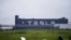 FILE - Tesla signage is seen at its factory in Shanghai, China, May 13, 2021.