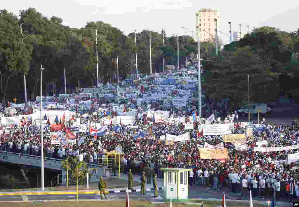 Thousands march through an avenue during a May Day march to Revolution Square in Havana, Cuba.