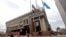 FILE - Flagpoles outside of Boston's City Hall fly U.S. and Massachusetts flags, with the third pole sometimes used by organizations. On Oct. 30, 2014, flags flew at half-staff for former Mayor Thomas Menino.