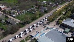 This video grab taken from a handout footage released by the Russian Defense Ministry on May 2, 2022 shows civilians being evacuated from an area near the Azovstal steel plant in Mariupol.