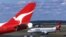 FILE - Two Qantas passenger jetsat Sydney International Airport, in Sydney, Australia, July 27, 2000. Researchers say in 2023 Australia's greenhouse gas emissions increased for the first time in five years, mostly because of an increase in post-COVID domestic air travel.