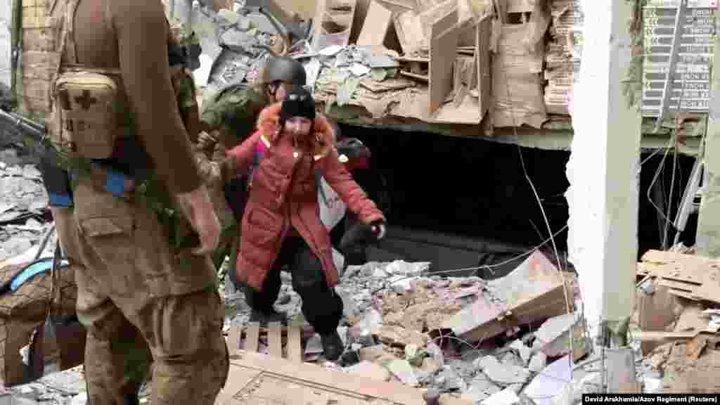 A child emerges from the Azovstal steel plant during UN-led evacuations after nearly two months of siege warfare on Mariupol, Ukraine, by Russia, in this still image from a video released May 1, 2022. Credit: David Arakhamia/Azov Regiment/Handout via REUT