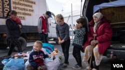 A refugee family waits for evacuation at refugee logistic center April 27, 2022, in Zaporizhzhia, Ukraine.