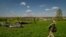 A Ukrainian soldier walks away from the site where a Russian helicopter was shot down during battle in the village of Malaya Rohan, outside Kharkiv, April 30, 2022.