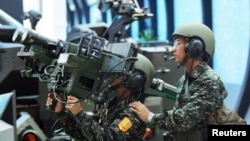 FILE - Soldiers from Taiwan demonstrate a US-made dual mount Stinger missile system Aug. 11, 2005.