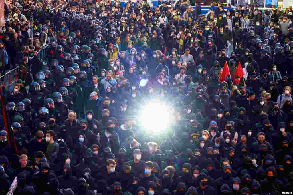 Police officers surround demonstrators as they take part in a May Day protest in Berlin, Germany, May 1, 2022.