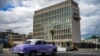 An old American car passes by the US embassy in Havana, Cuba on May 3, 2022.