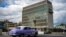 An old American car passes by the US embassy in Havana, Cuba on May 3, 2022.