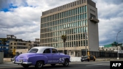 An old American car passes by the US embassy in Havana, Cuba on May 3, 2022, as the consulate resumed issuing some immigrant visa services which have been suspended since 2017 following alleged "sonic attacks."