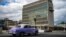 An old American car passes by the U.S. embassy in Havana, Cuba, May 3, 2022.