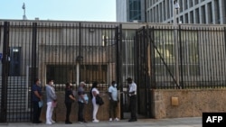 People queue at the US embassy in Havana, Cuba on May 3, 2022, as the consulate resumed issuing some immigrant visa services.