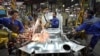FILE - Iranian car workers weld parts of a car body, at the state-run Iran Khodro automobile manufacturing plant, which they claim is the largest car maker in the Middle East, near Tehran, Iran, April 20, 2011.