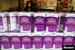 FILE - COVID-19 home test kits are pictured in a store window in the Manhattan borough of New York City, New York, Jan. 19, 2022.