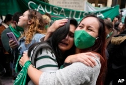 Abortion-rights activists celebrate after the decriminalization of abortion in Colombia, Monday, Feb. 21, 2022. (AP Photo/Fernando Vergara, FIle)