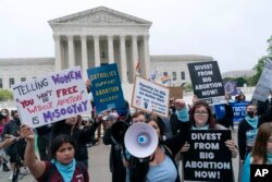 Demonstrators protest outside of the U.S. Supreme Court, May 3, 2022 in Washington.