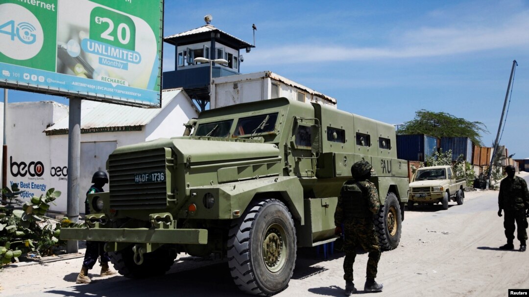 FILE - African Union peacekeepers stand next to an armored personnel carrier as they provide security for members of the Lower House of Parliament who are meeting to elect a speaker, at the Aden Adde International Airport in Mogadishu, Somalia, April 27, 2022.