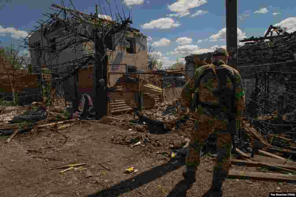A soldier observes the destruction of a residential neighborhood in Zaporizhzhya, April 28, 2022.