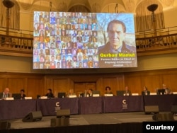 A testimonial slideshow of Bahram Sintash is displayed on the screen of the Uyghur Tribunal, in London, 2021. (Photo courtesy of Bahram Sintash)