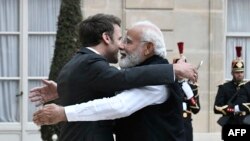 France's President Emmanuel Macron, left, welcomes India's Prime Minister Narendra Modi for a meeting at the Elysee Palace in Paris, on May 4, 2022. 