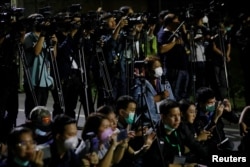 Journalists wearing masks wait for Thai citizens evacuated from Wuhan at U-Tapao Airport, in Rayong, Thailand February 4, 2020. REUTERS